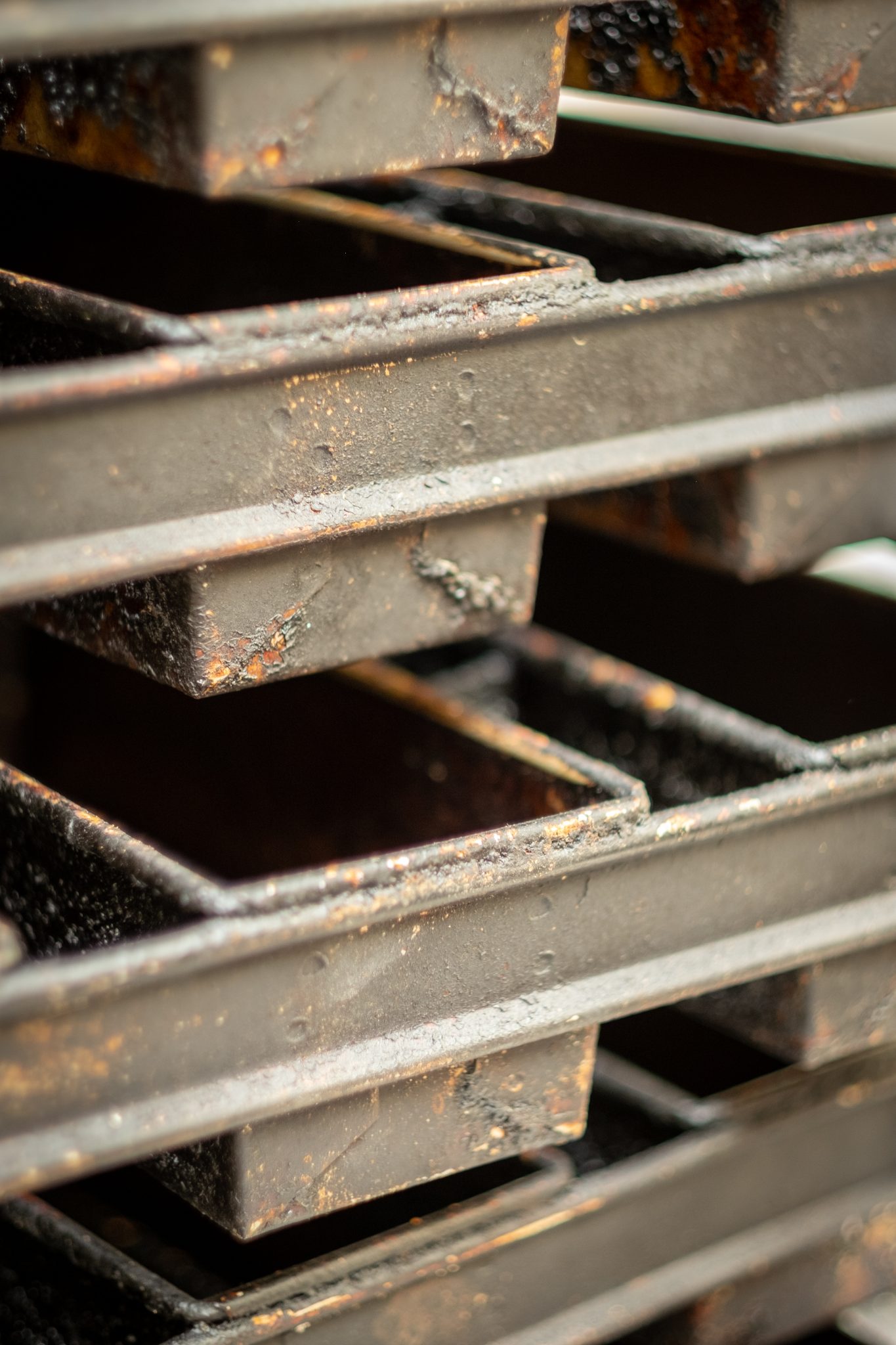 Baking trays stacked on a rack in a bakery